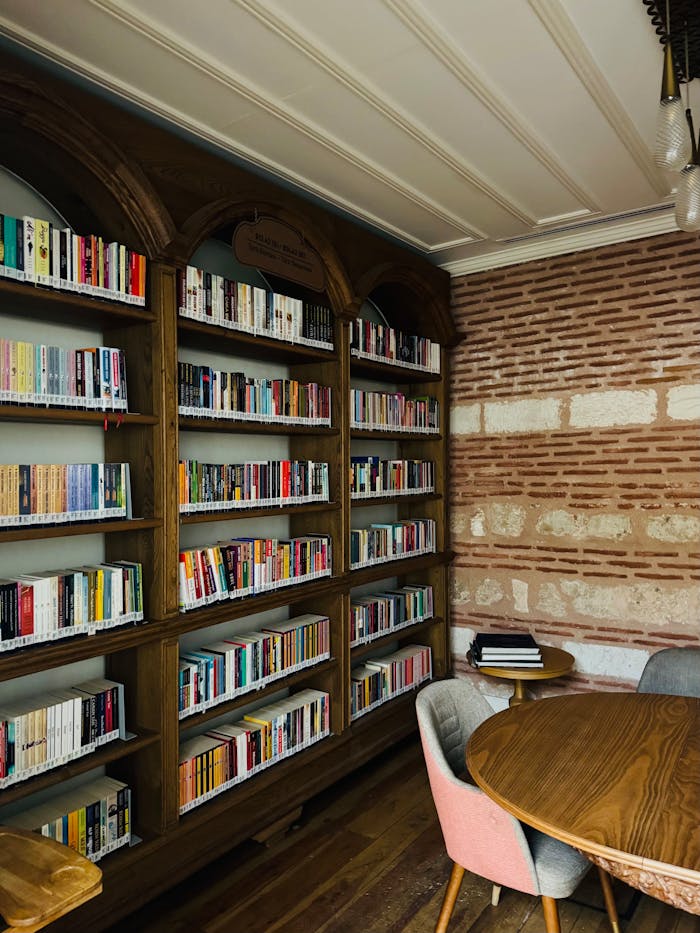 Warm and inviting library corner with bookshelves and seating, ideal for reading.